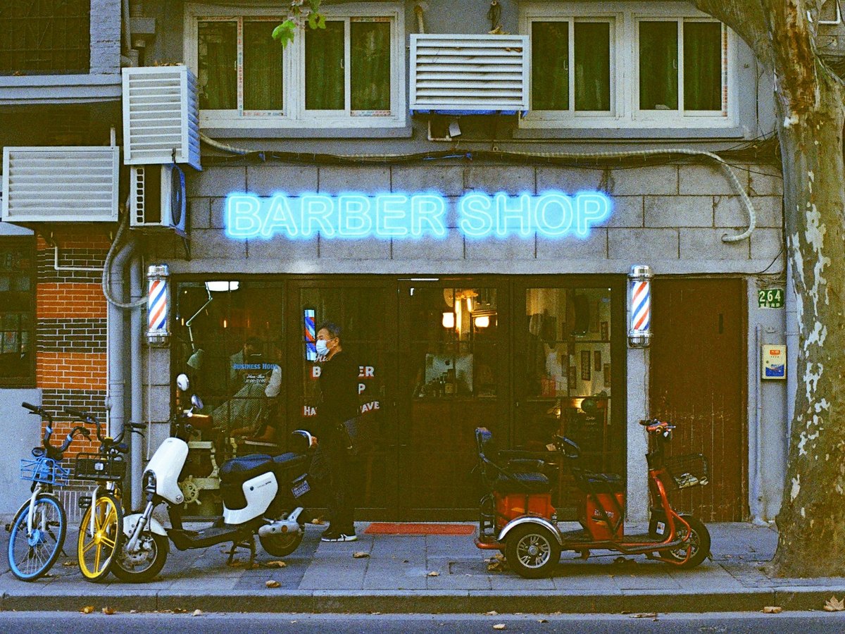 red and black motorcycle parked beside the building