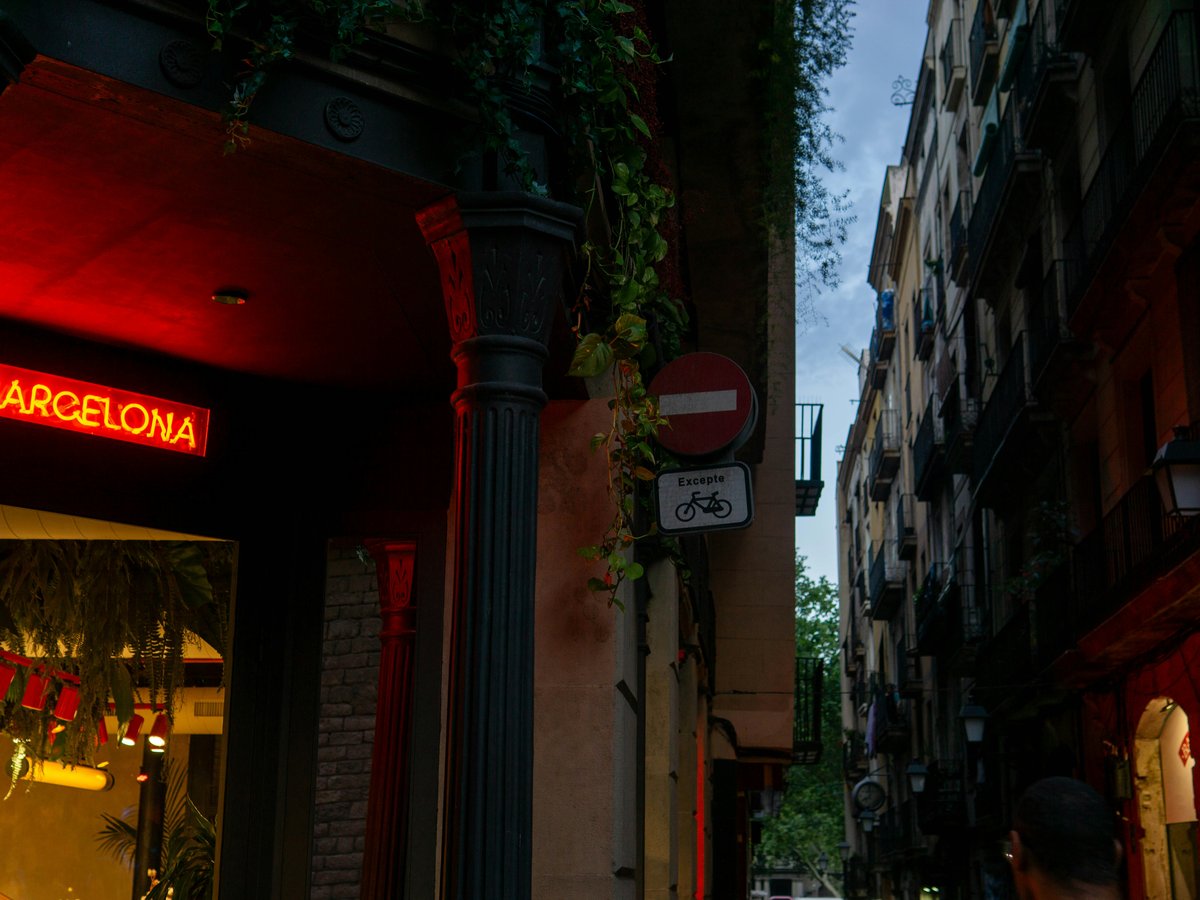 Neon sign for barcelona in a narrow street