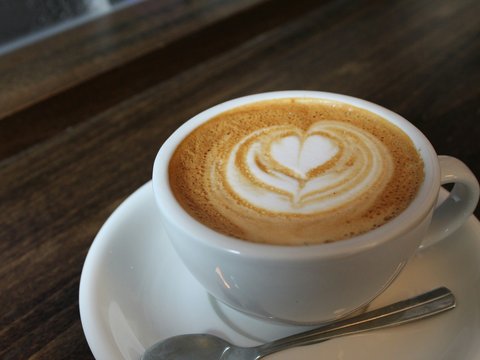a cup of cappuccino with a heart drawn on it