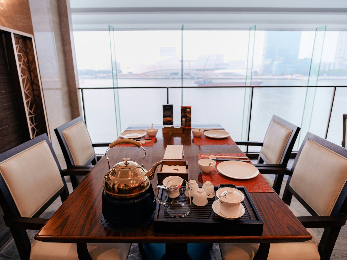 a wooden table with plates and cups on it