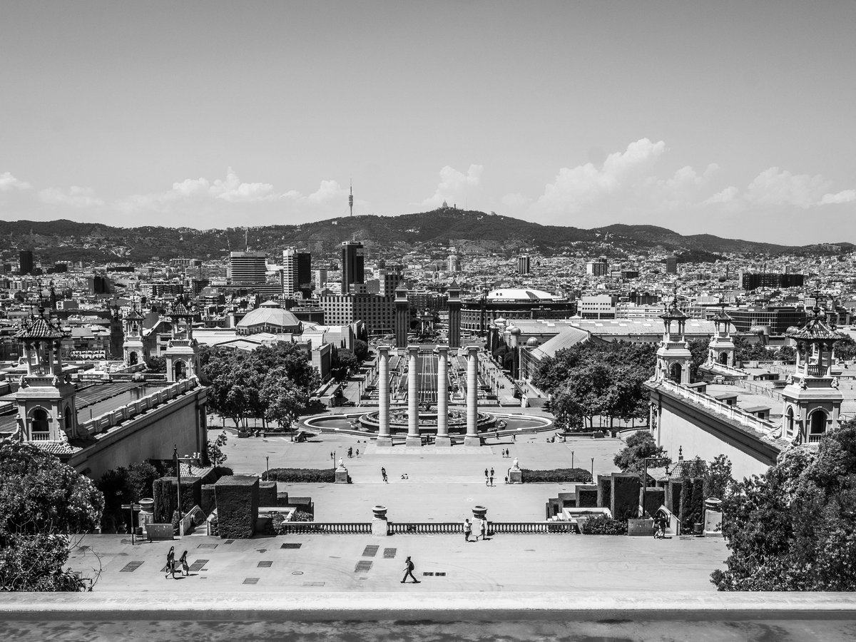 grayscale photography of city with high-rise buildings viewing people walking