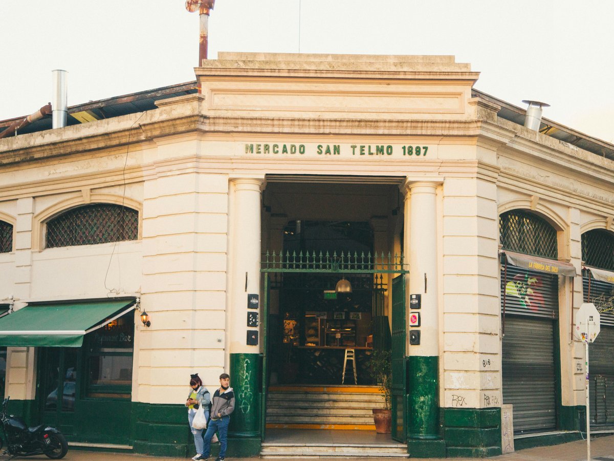 a couple of people standing outside of a building