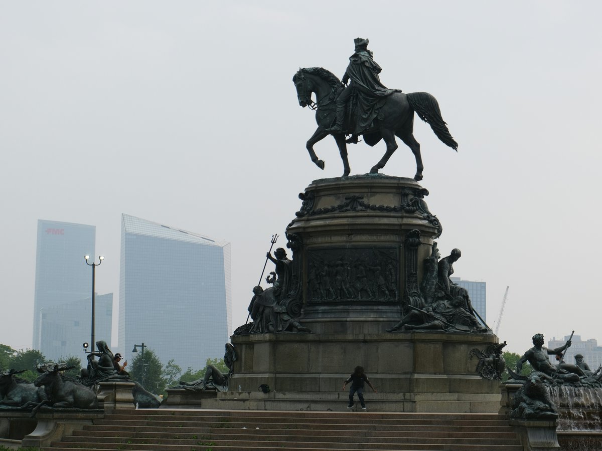 A statue of a man on a horse in a park
