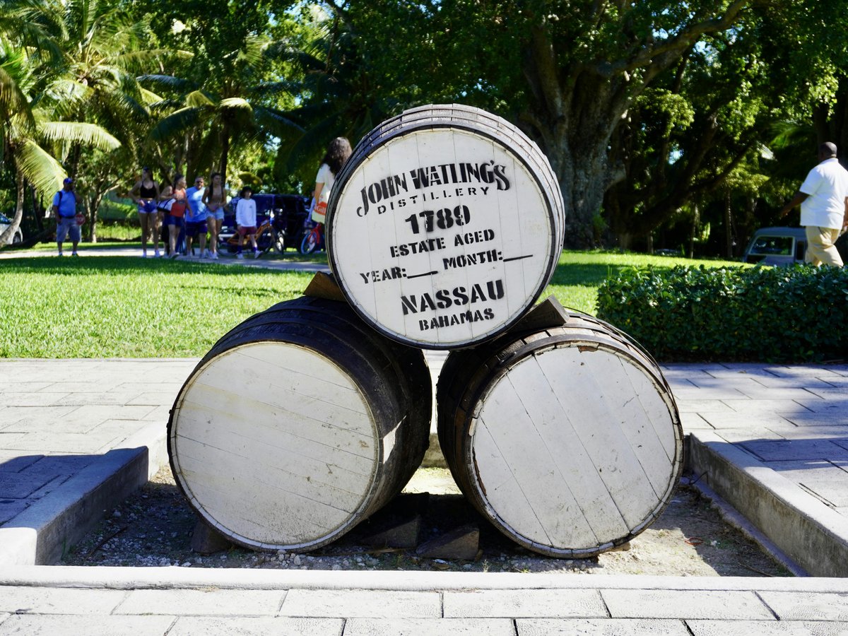 a couple of barrels sitting on top of a sidewalk