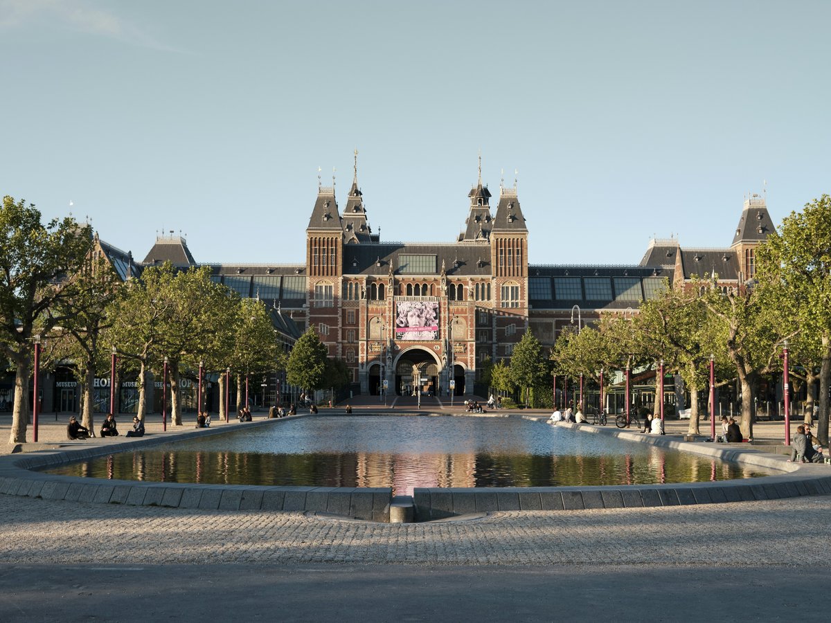 people walking on park near brown building during daytime