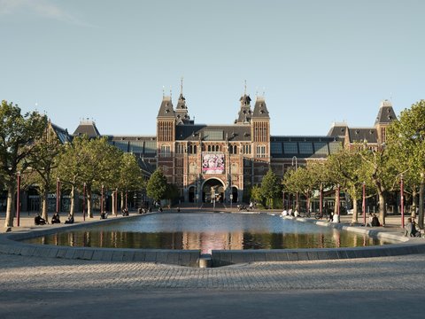 people walking on park near brown building during daytime