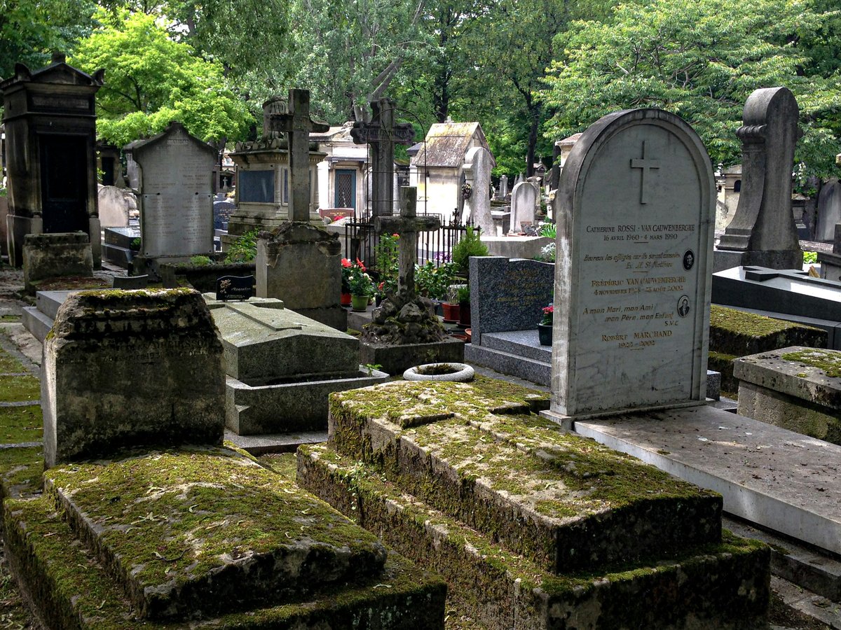 gray concrete tomb near green trees during daytime