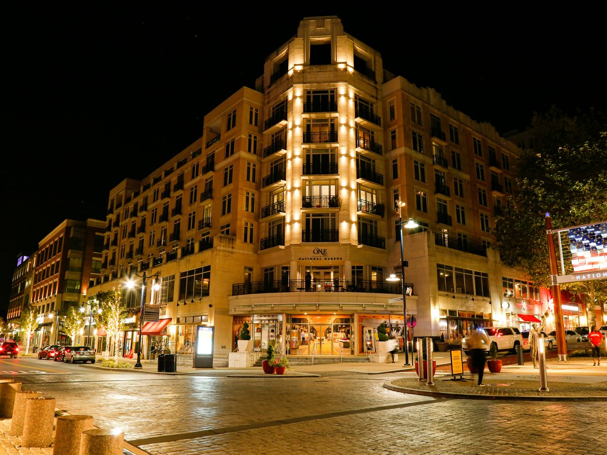 people walking on street near brown concrete building during night time