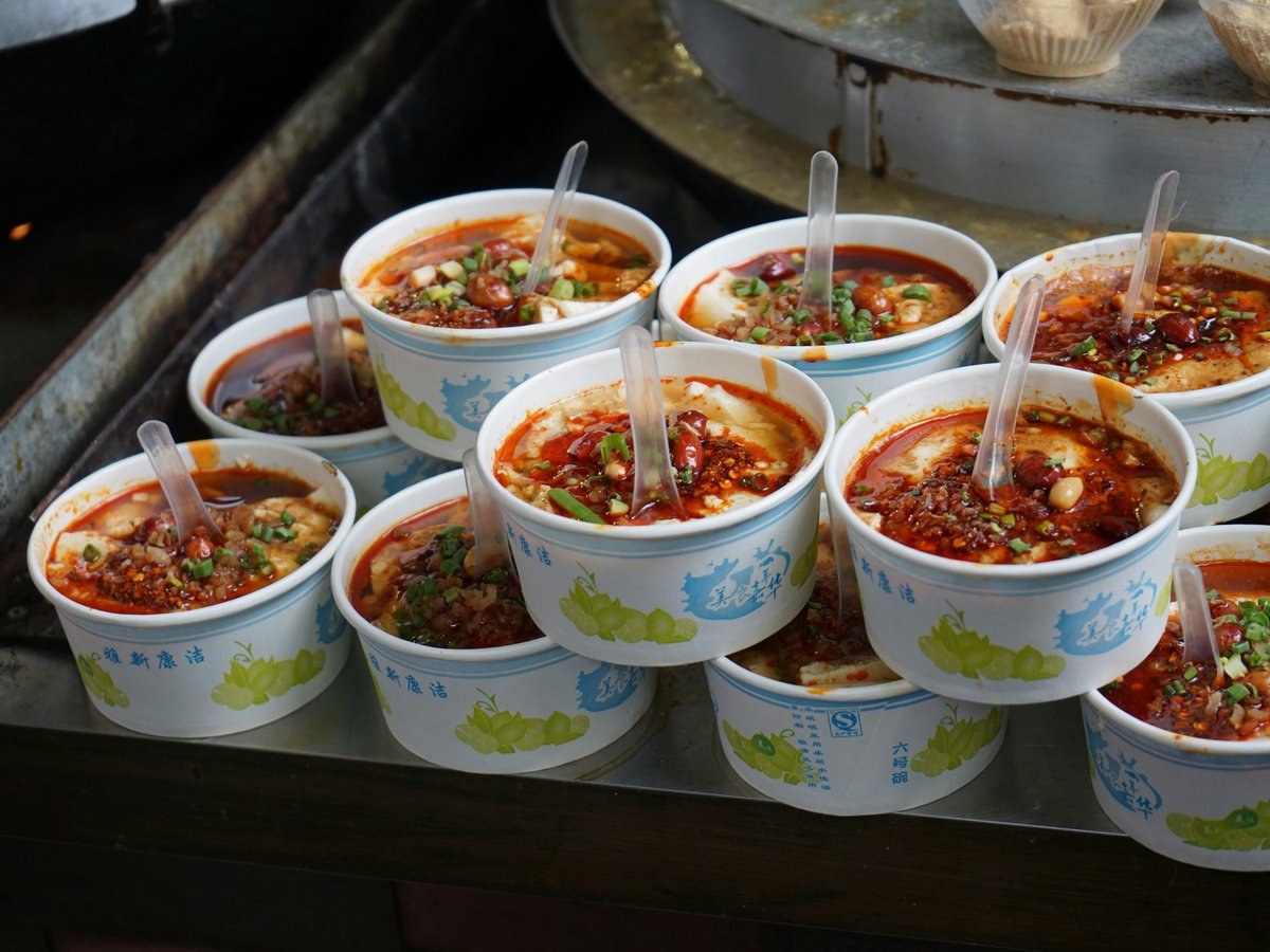 A bunch of bowls of food sitting on a table