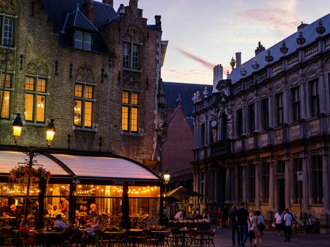 a group of people walking around a town square