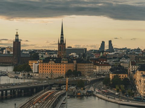 A view of a city with a bridge in the foreground