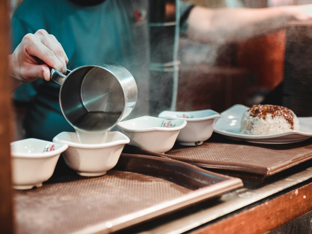 a person cooking food on a stove