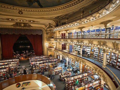 high-angle photo of people inside library with mini stage on room's corner