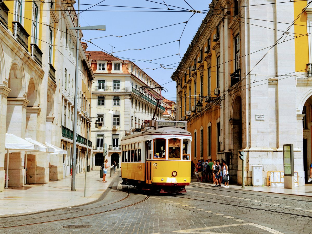 yellow and white tram on road during daytime