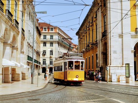 yellow and white tram on road during daytime