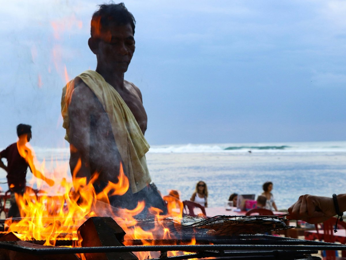 A man standing in front of a fire pit