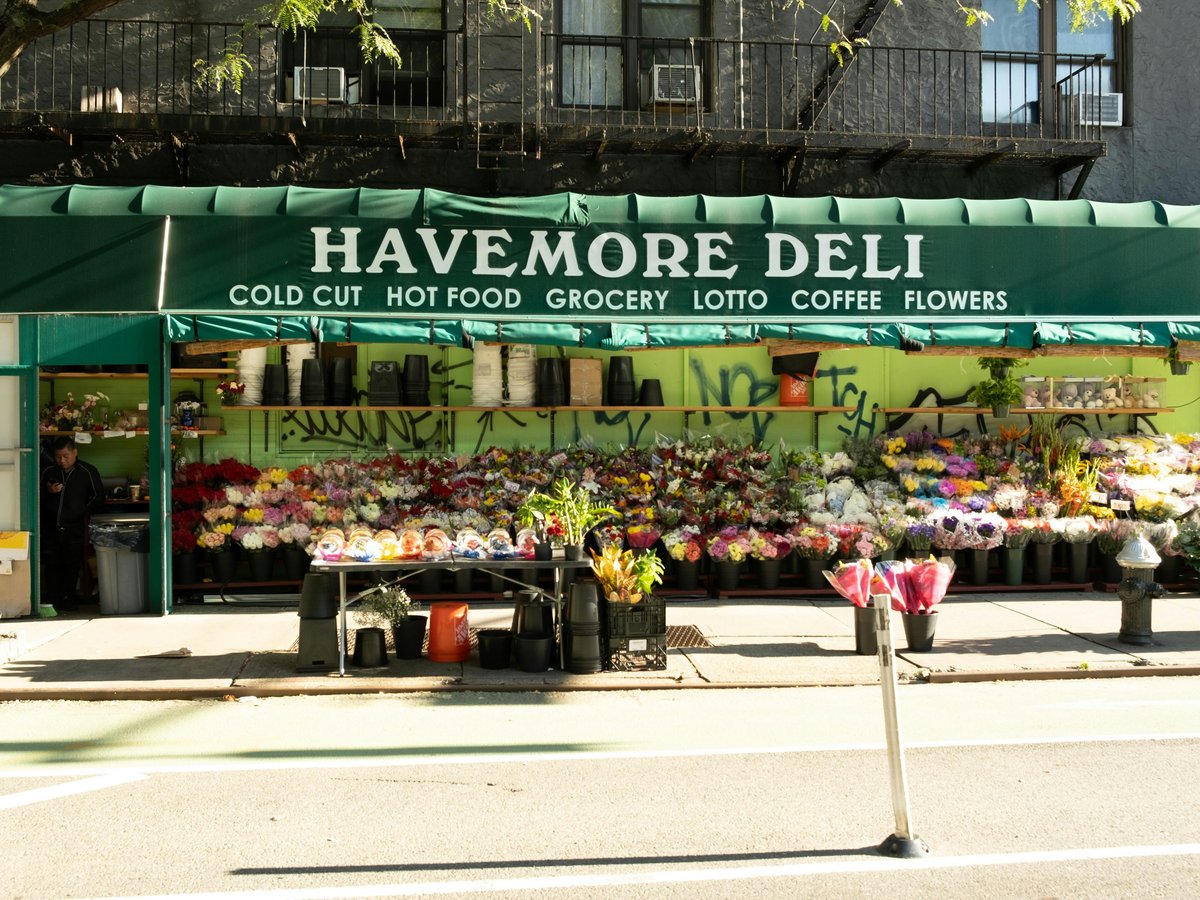 A street corner with a flower shop on the corner