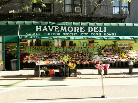 A street corner with a flower shop on the corner