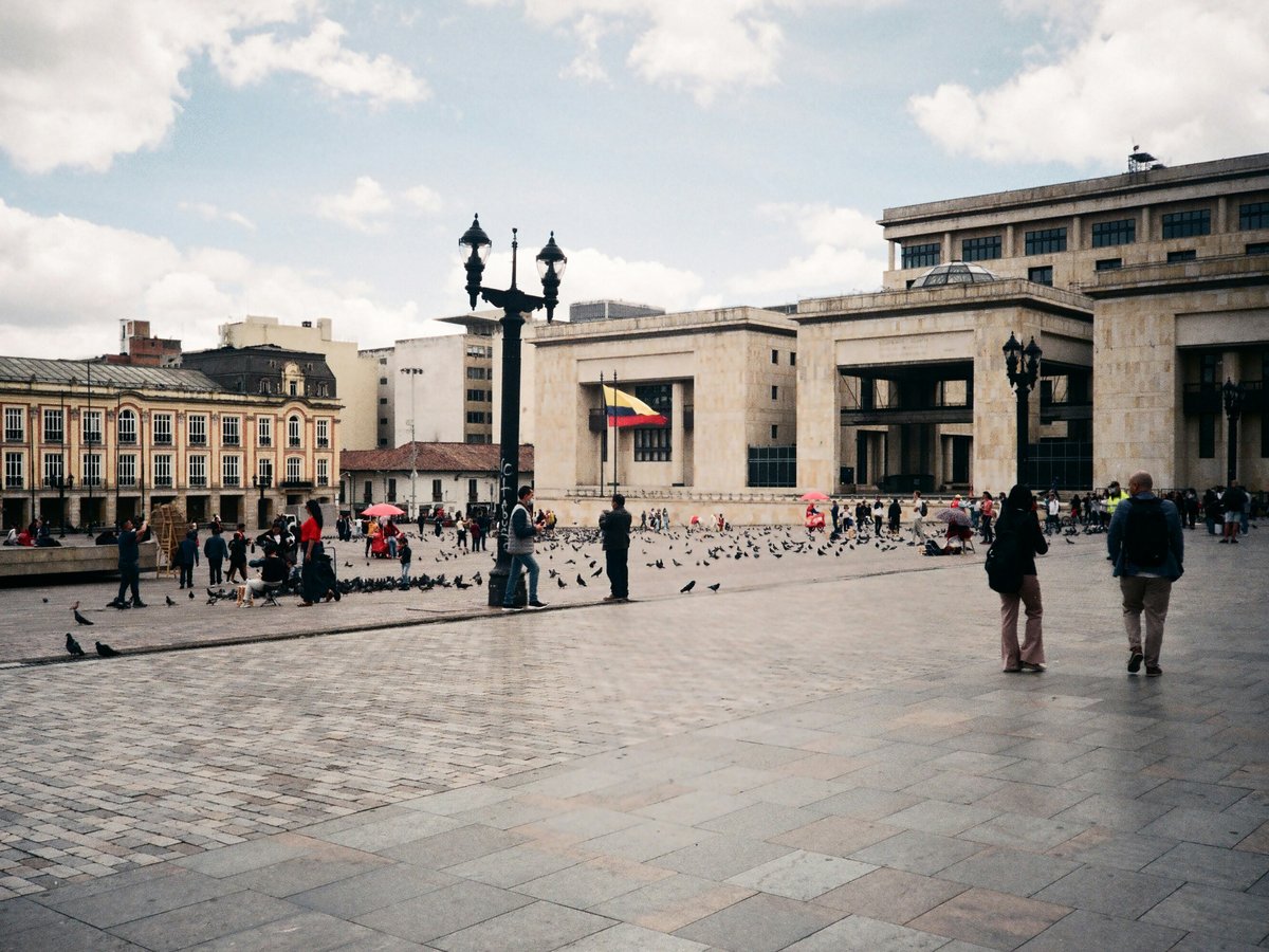 A group of people walking around a courtyard