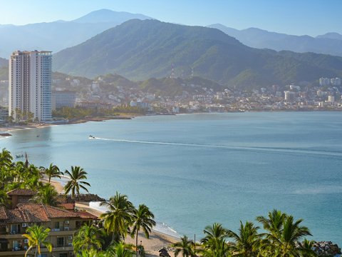 A view of a beach with a city in the background