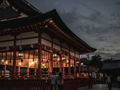 people standing in front of pagoda