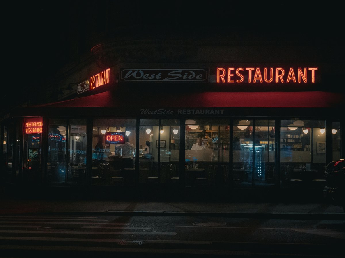 a restaurant that is lit up at night