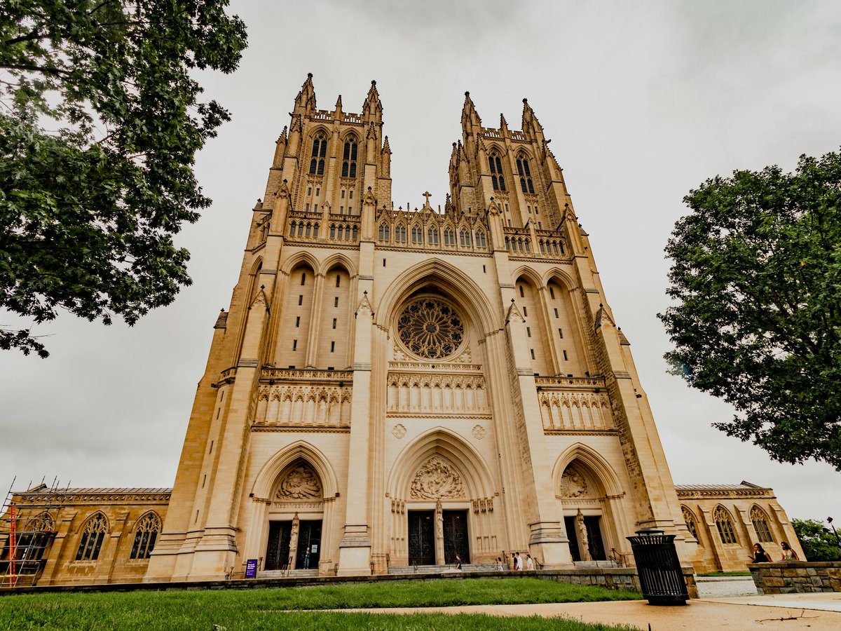 The majestic washington national cathedral towers over the lawn.