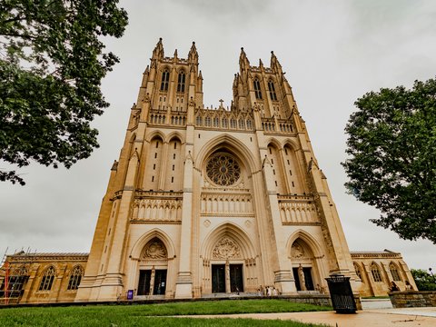 The majestic washington national cathedral towers over the lawn.