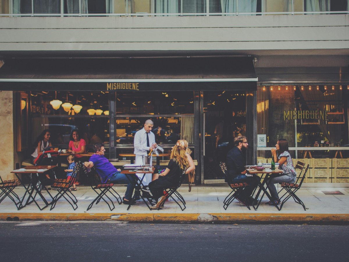 people sitting on chairs in front of facade