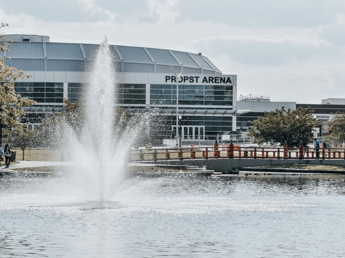 a water fountain in front of a large building
