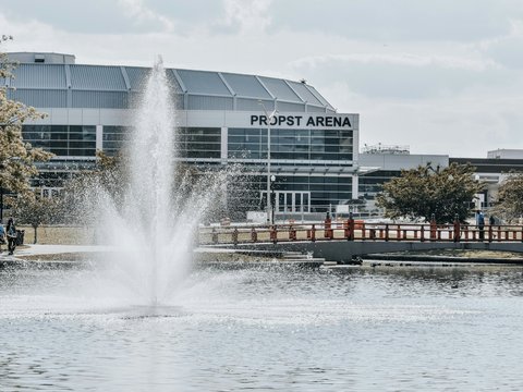 a water fountain in front of a large building