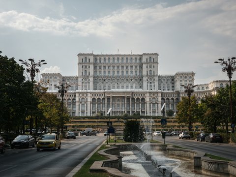 a large building with a fountain in front of it