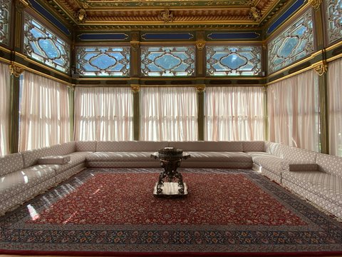 a room with a red carpet and a large chandelier