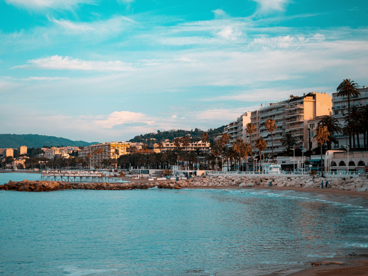 city buildings near body of water under blue sky during daytime