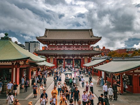 a group of people standing around a building