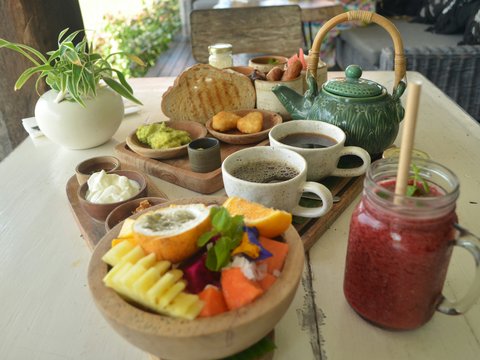 a wooden tray topped with bowls of food