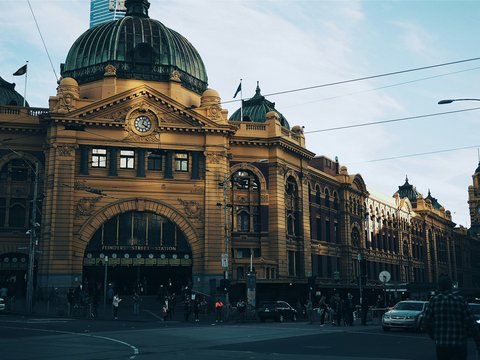 brown building with cars passing infront