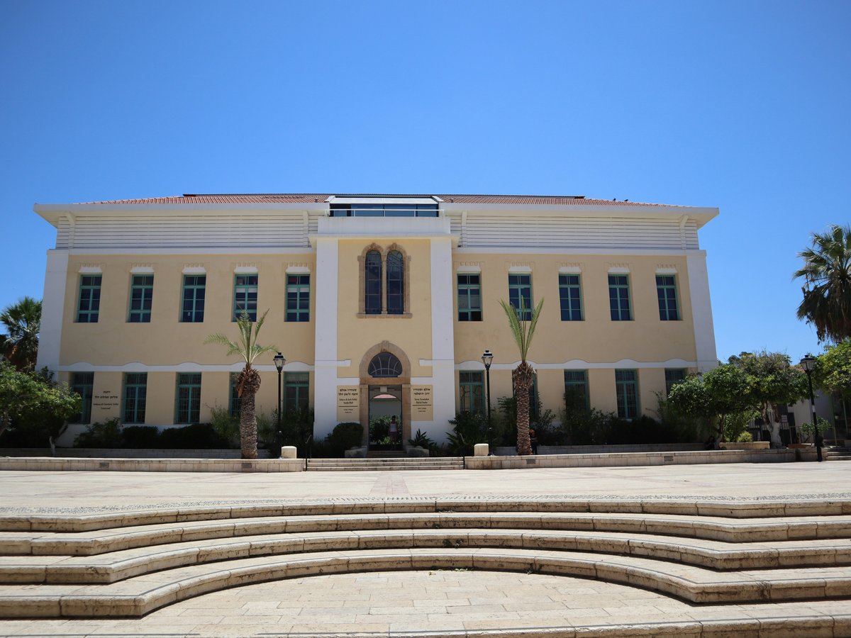 a large yellow building with steps leading up to it