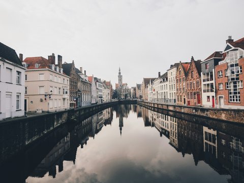 river in between houses during daytime