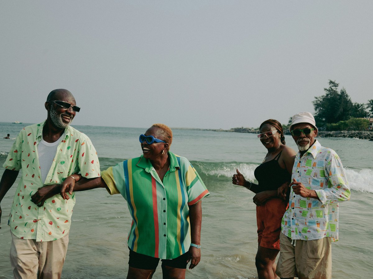 A group of people standing on top of a beach