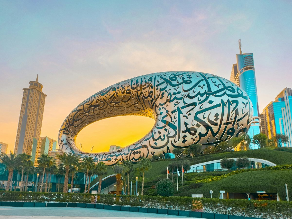 a large sculpture of a whale in front of a cityscape