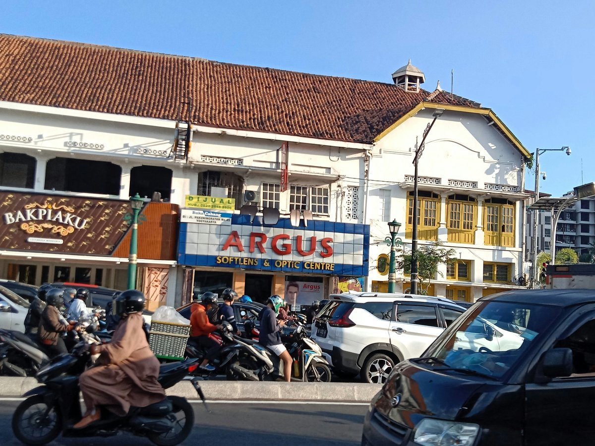 a group of people riding motorcycles down a street