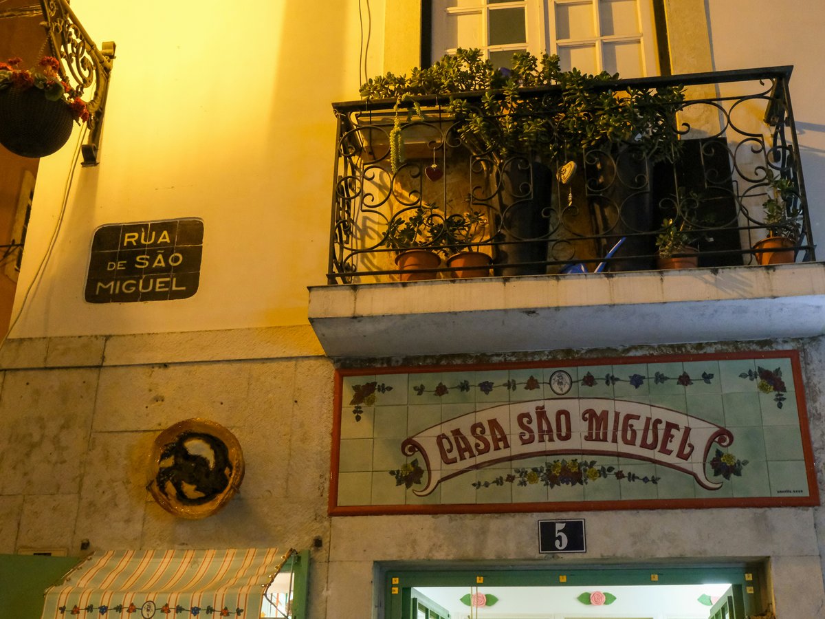 Building facade with "casa sao miguel" sign and balcony
