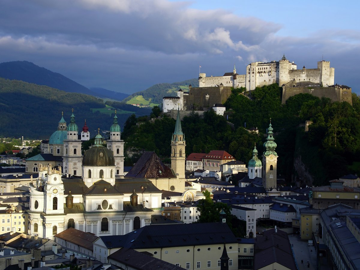 A view of a city with a castle in the background