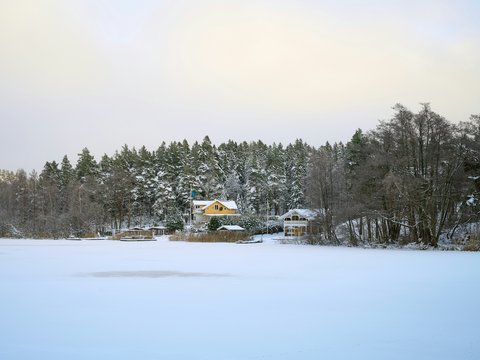 a snow covered field with a house in the background