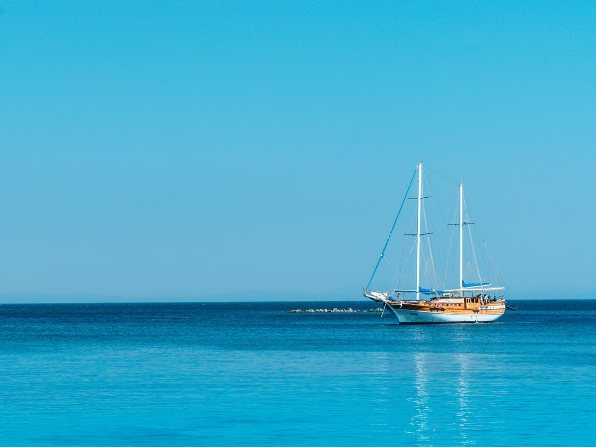 boat on body of water under blue sky at daytime