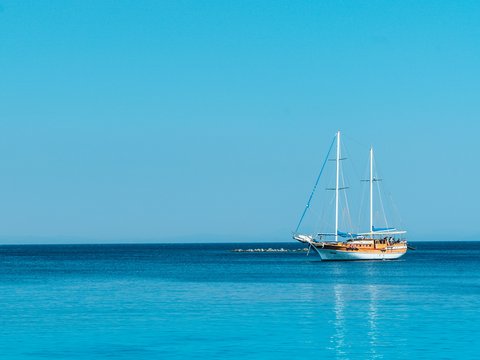 boat on body of water under blue sky at daytime