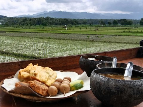 a plate of food sitting on top of a wooden table
