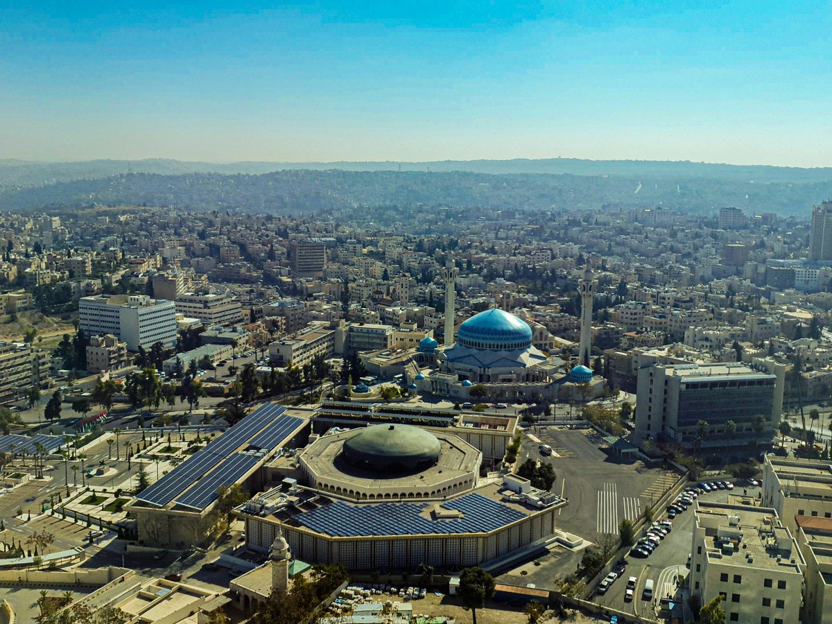 An aerial view of a city with buildings and a dome