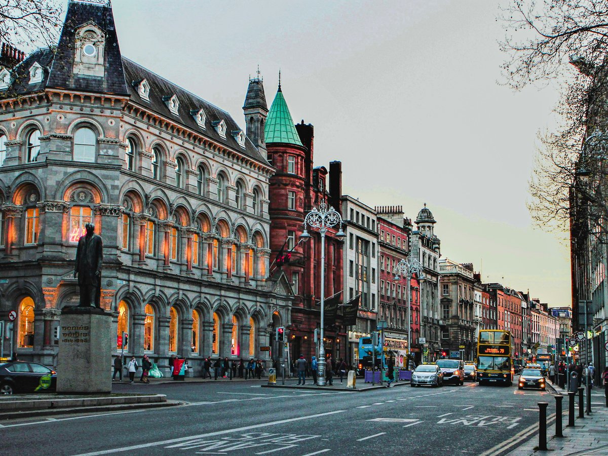 a city street with a clock tower in the middle of it